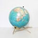 Luminous world map in tripod glass