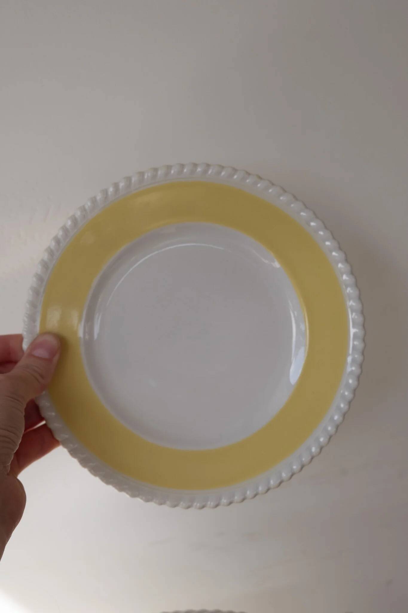 Vintage yellow butter ceramic dinnerware set with swirl border.