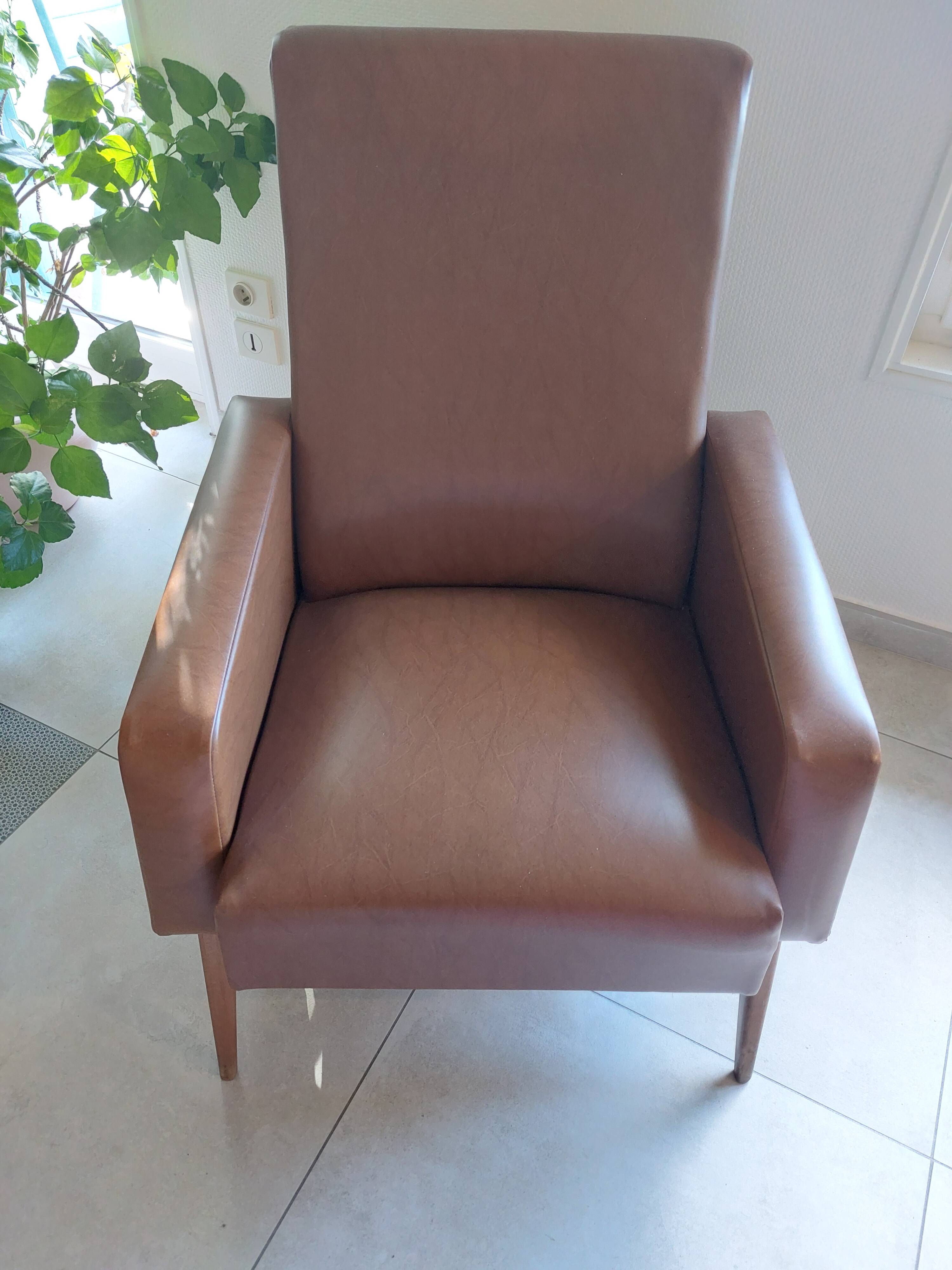 a pair of comfortable vintage armchairs with splayed legs