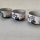 Three glazed ceramic bowls with raised graphic decoration, 1970s.