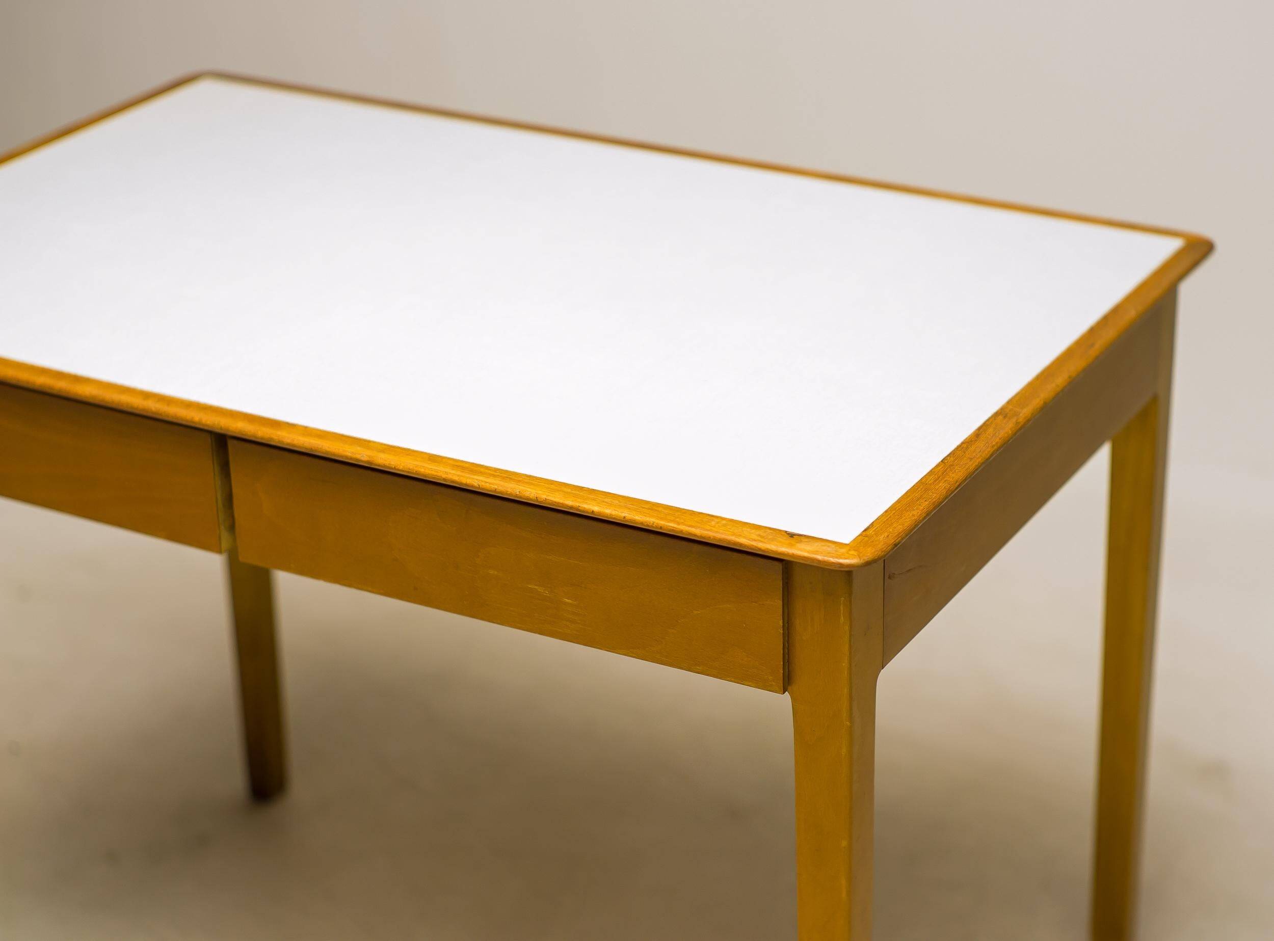 Small maple desk with a laminate top and two drawers, Fritz Hansen, 1950s.