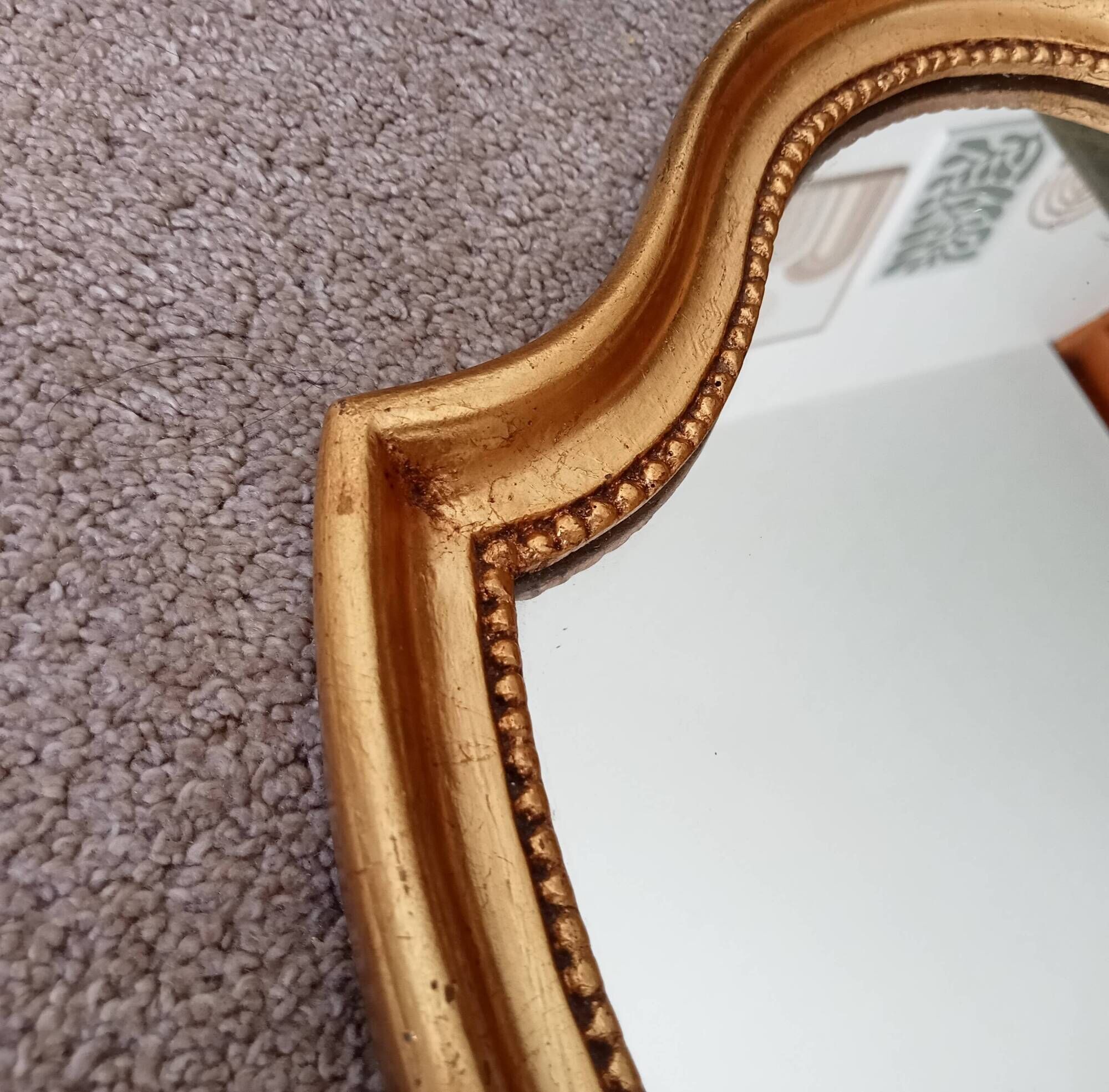 Vintage baroque mirror in gilded wood in the Louis XV style.
