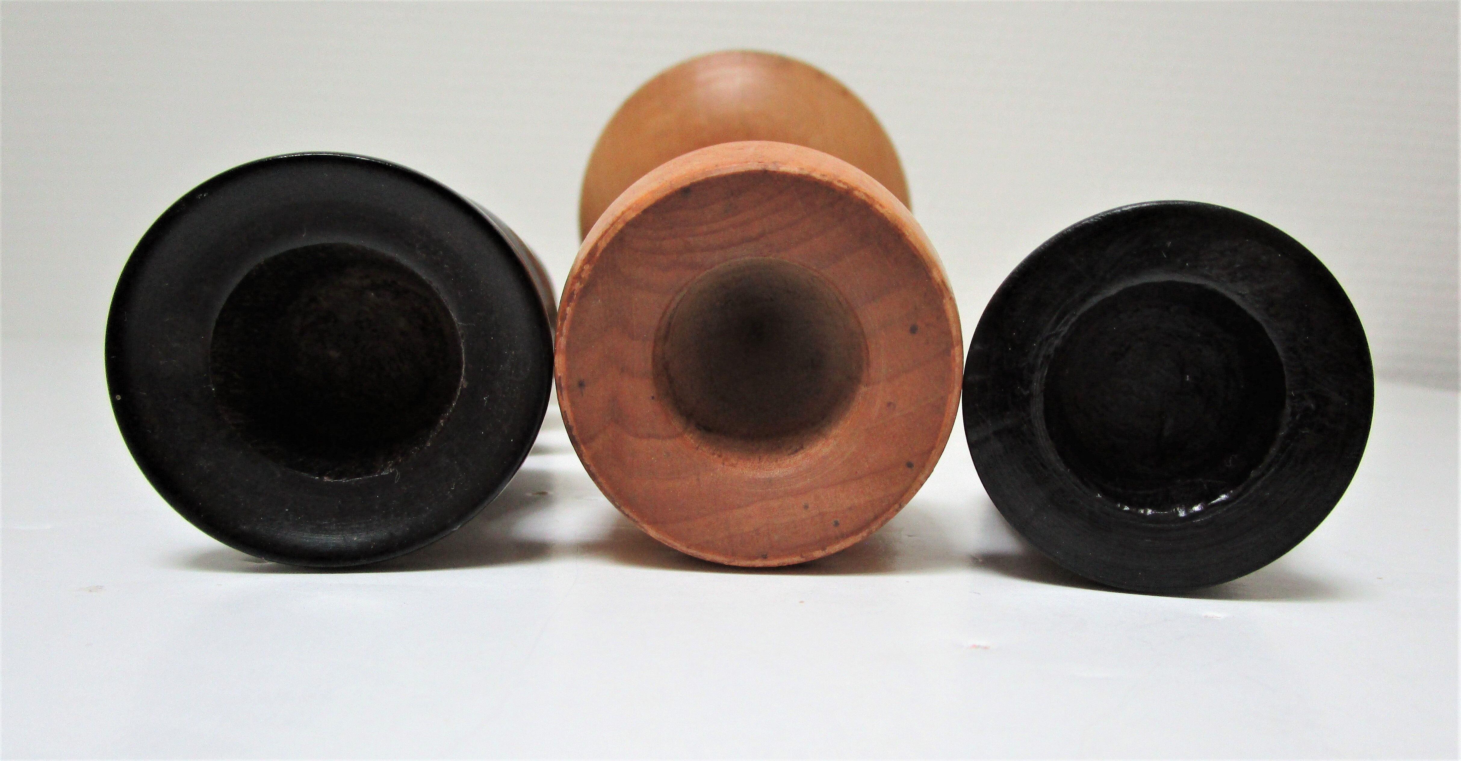 Three vintage light and dark wood candlesticks