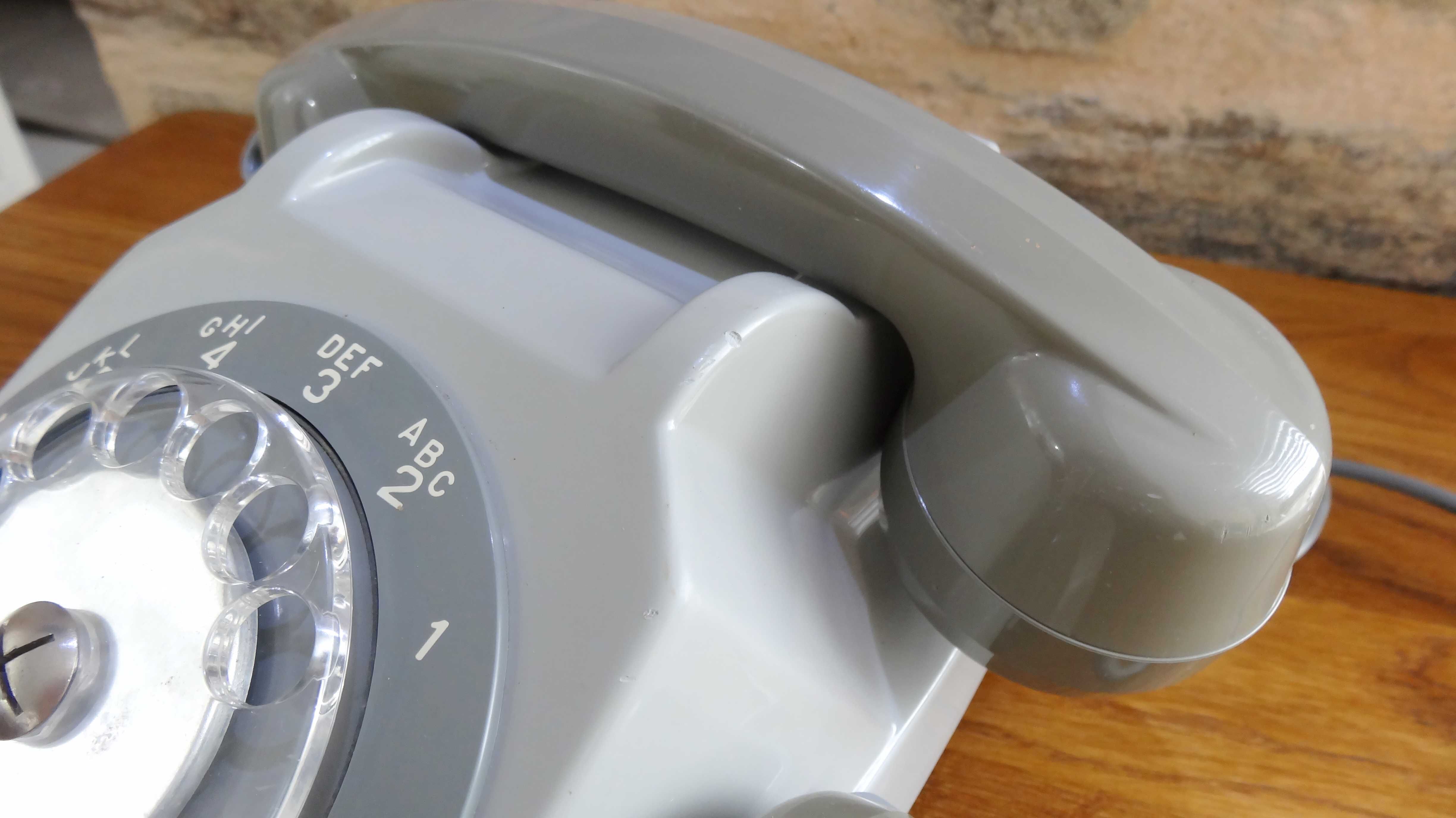Grey vintage rotary dial phone with earpiece