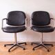 Pair of vintage swivel armchairs in metal and black faux leather.