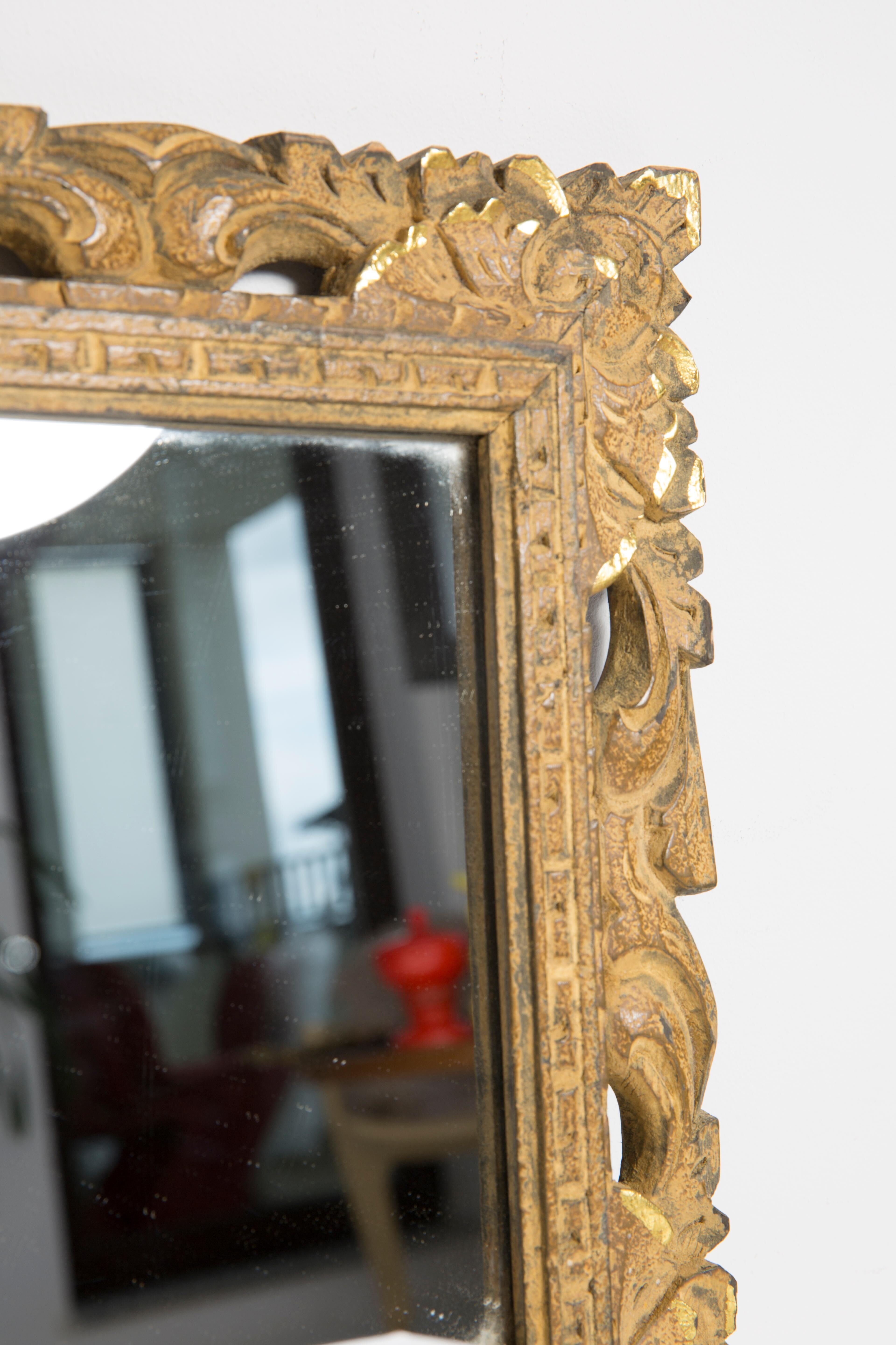 Decorative gold mirror mid-century in a wooden frame, Italy, 1960s.