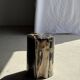 Black petrified wood side table with beige stripes, star pattern H35 D24.