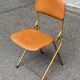 Eyrel folding chair in brass and leather from the 1960s.