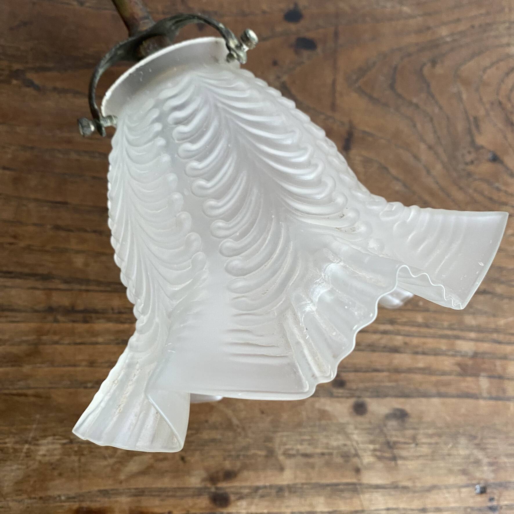 Antique swan neck wall light in brass and porcelain with a glass shade.
