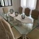 Table with a glass top and 8 chairs.
