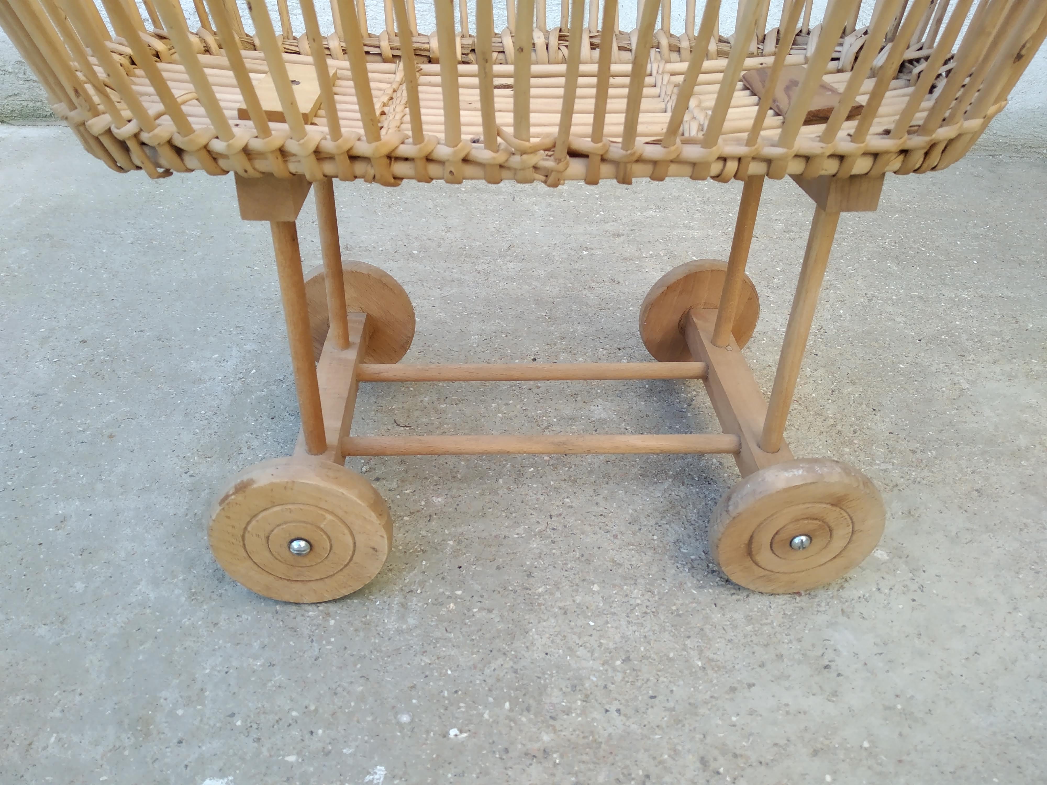 Rattan cradle for doll on vintage wheels