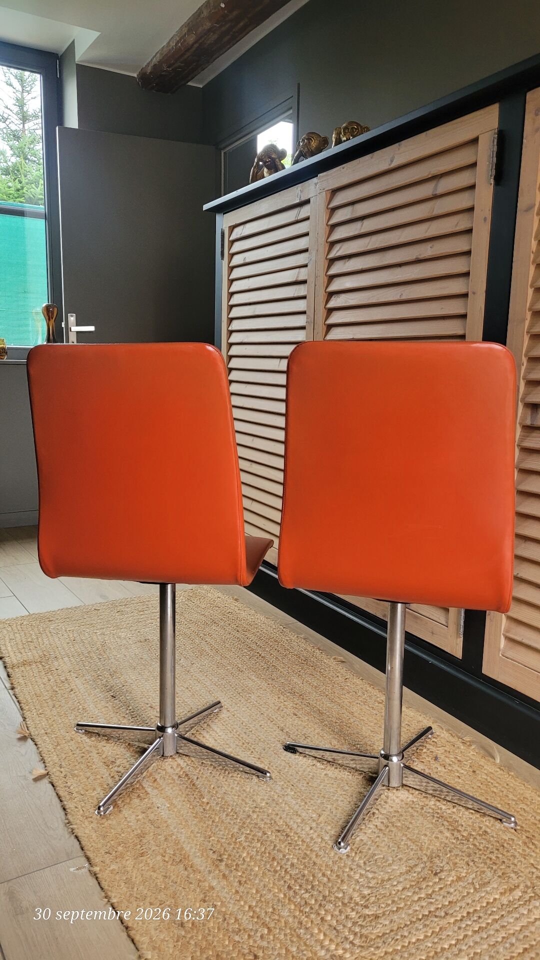2 orange faux leather swivel chairs