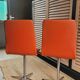 2 orange faux leather swivel chairs