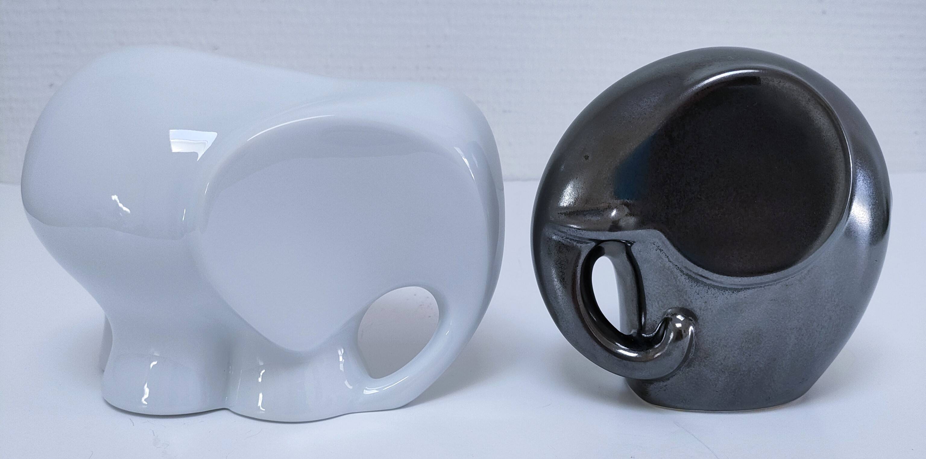 Two iridescent black and white ceramic elephants design