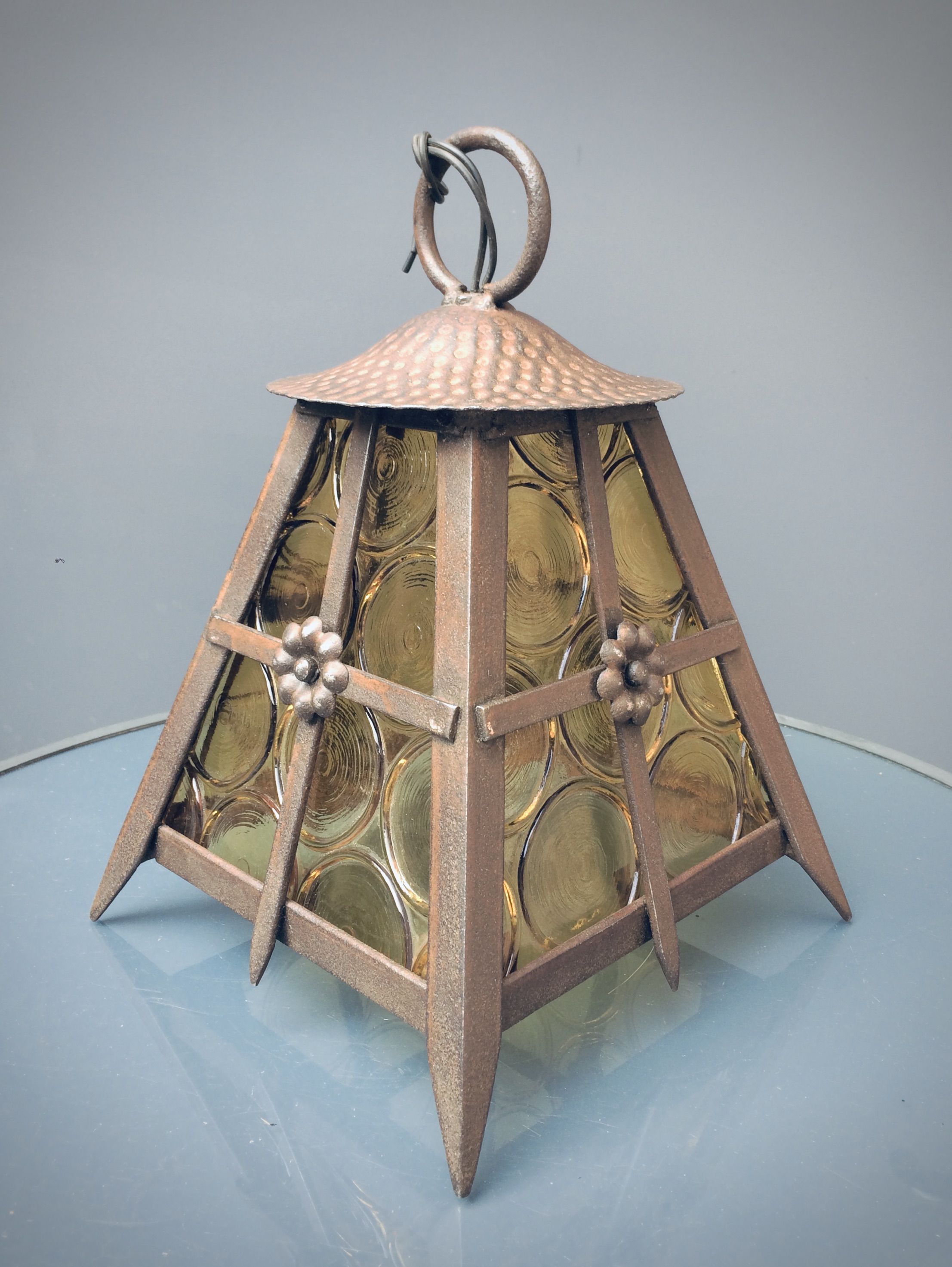 Old solid steel hanging and round-ornamented yellow glazing