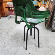 Vintage swivel workshop chair in green pressed sheet metal with a folding backrest.