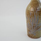 Brown ceramic/stoneware bottle with chiseled floral pattern