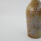 Brown ceramic/stoneware bottle with chiseled floral pattern
