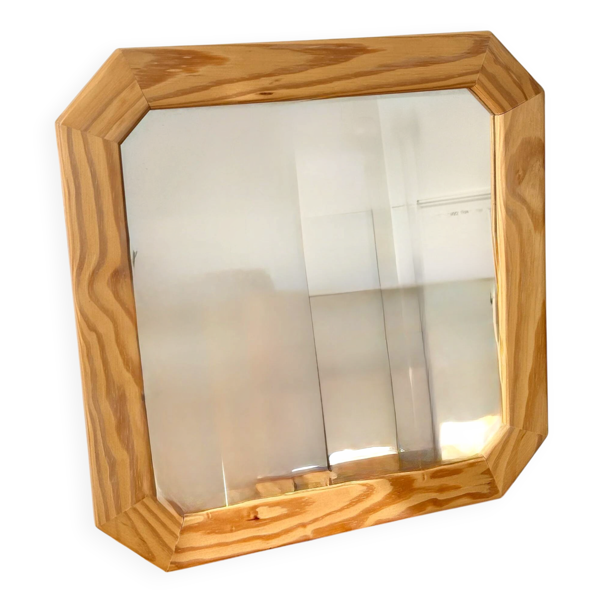 Octagonal mirror in light wood with grooves.