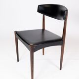 Set of four dining room chairs in rosewood and black leather of danish design from the 1960s.