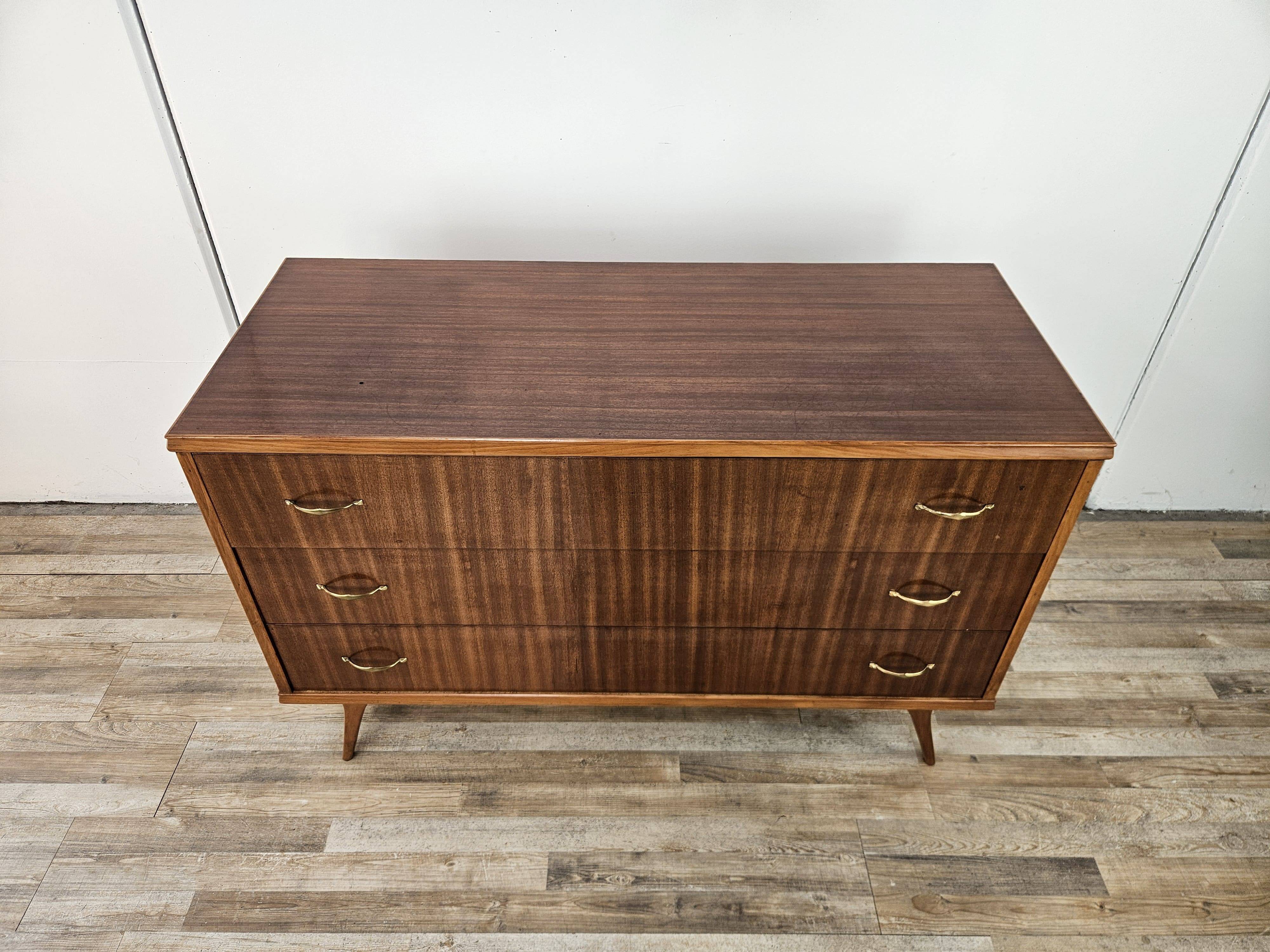 1950s chest of drawers covered in walnut with brass handles