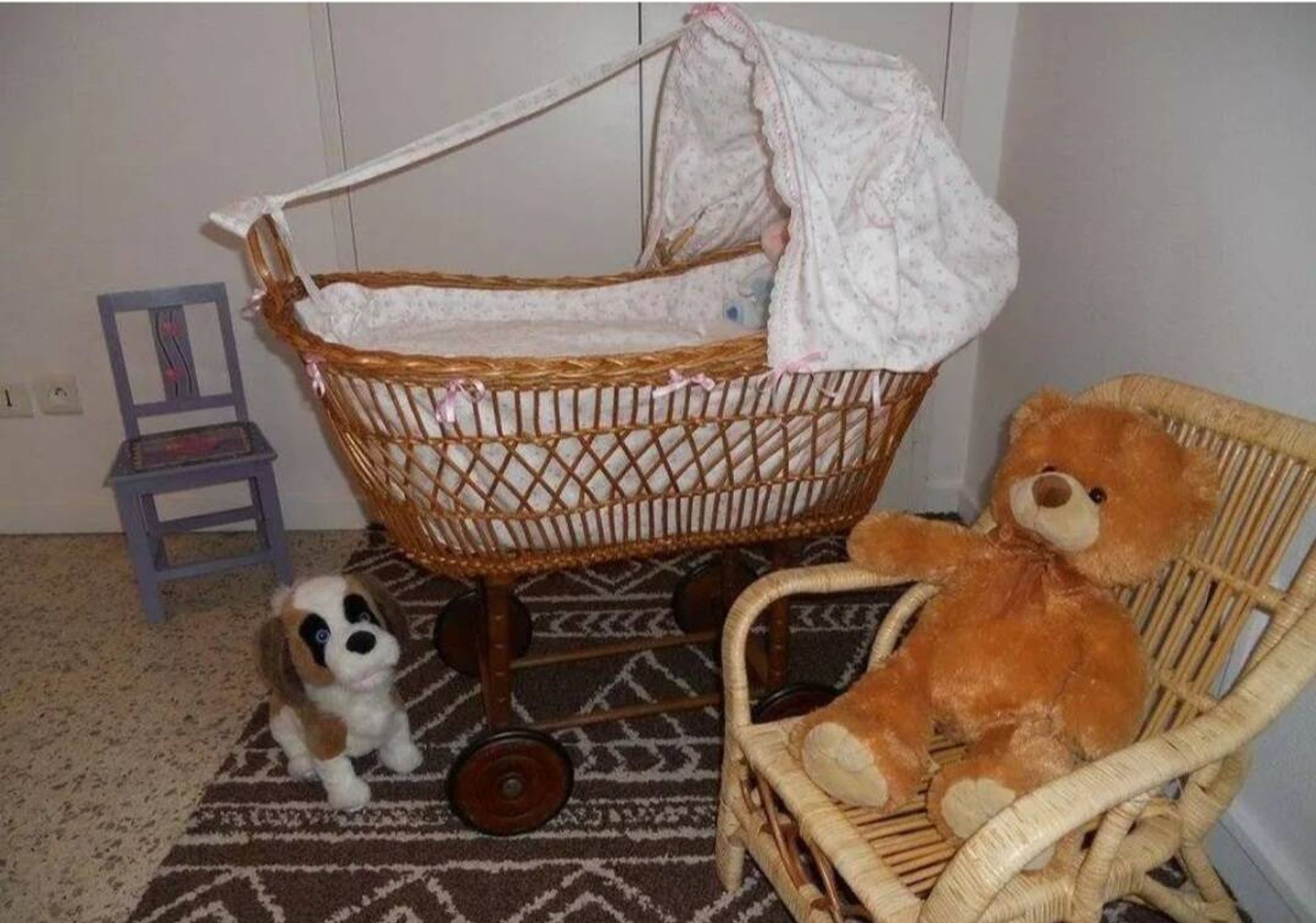 Vintage wicker cradle on wheels from the 1970s.