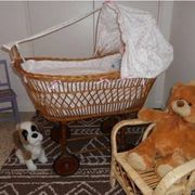 Vintage wicker cradle on wheels from the 1970s.