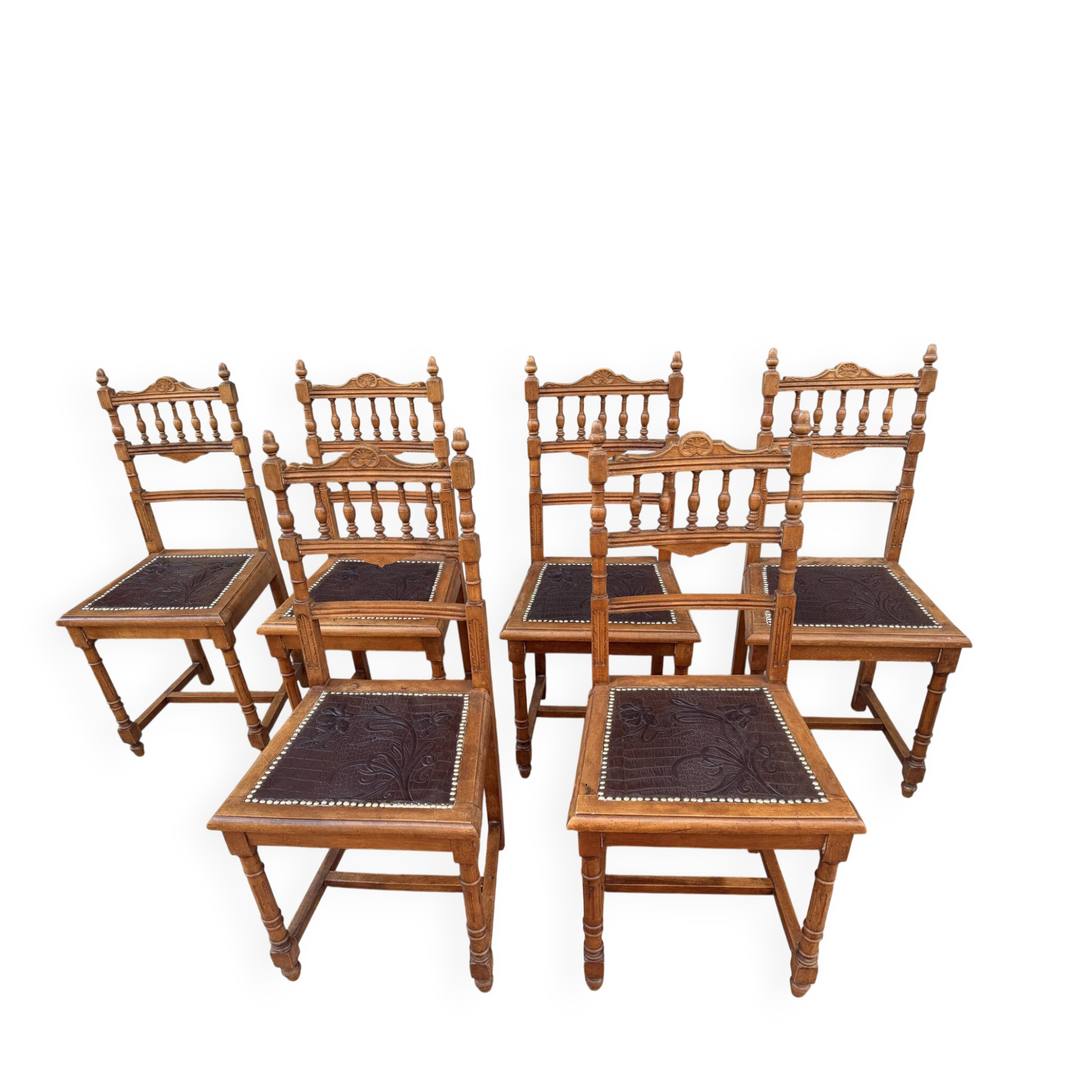 Set of 6 antique turned wooden chairs with embossed leather seats.