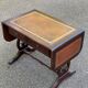 Victorian English extendable coffee table made of solid mahogany and leather.