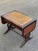 Victorian English extendable coffee table made of solid mahogany and leather.