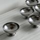 5 silver metal cups.