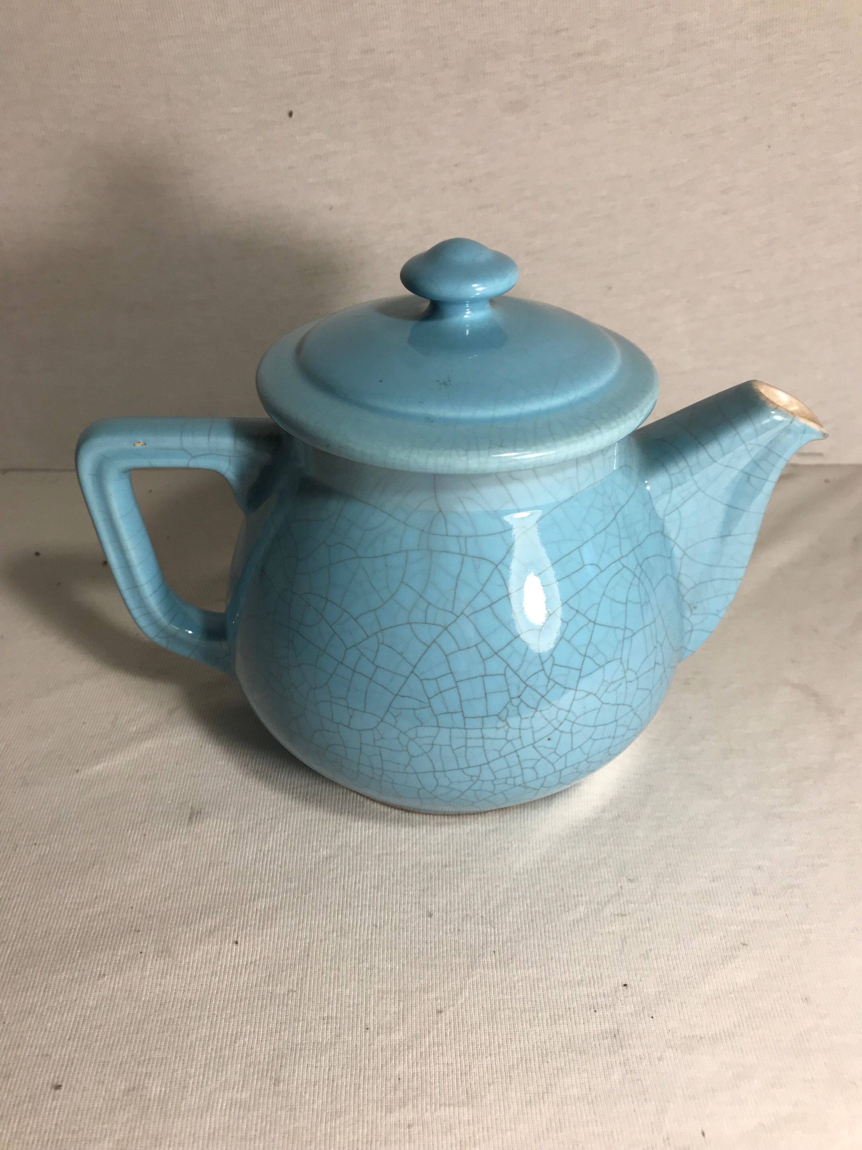 Cracked blue ceramic vintage teapot