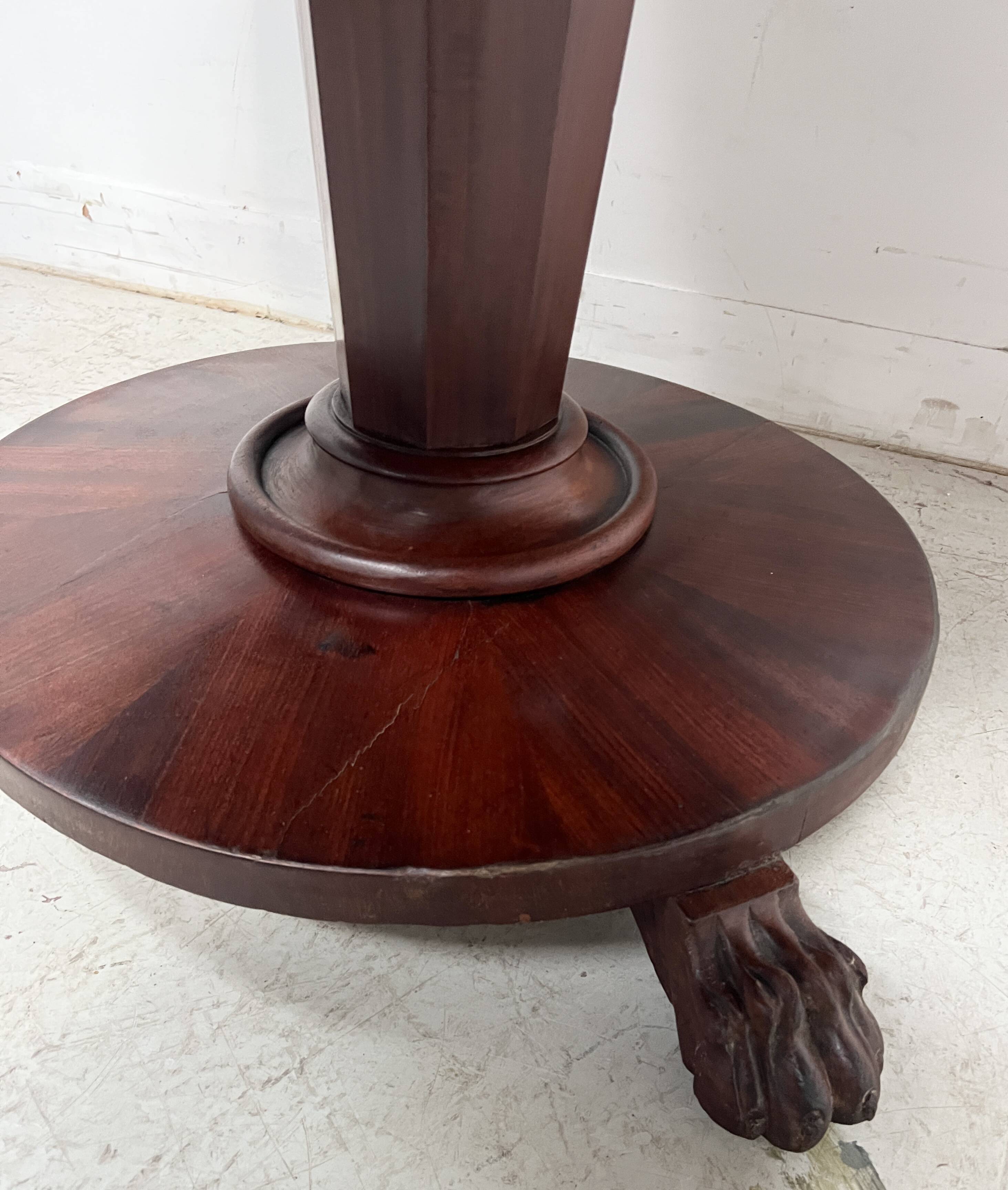Empire style round table with claw feet, 19th century.