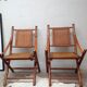 Pair of folding chairs in bamboo and caning, leather and brass