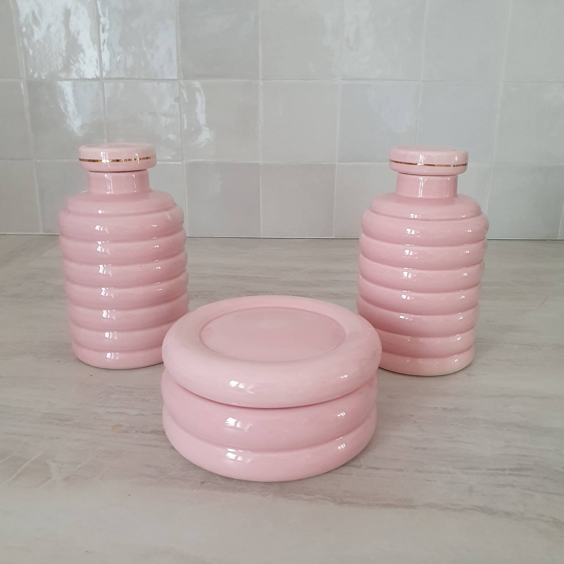 Set of pink and gold ceramic bathroom accessories