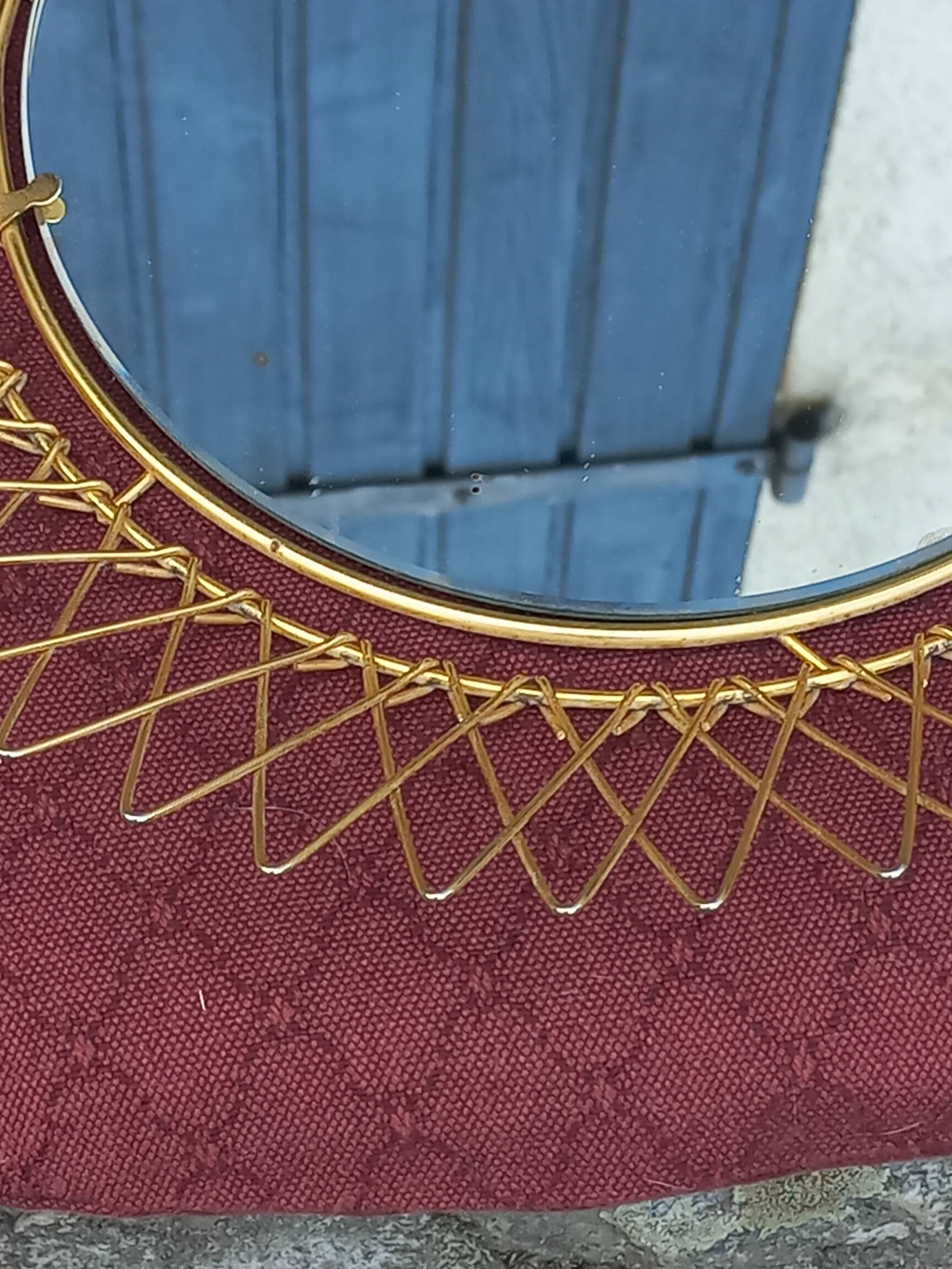 Vintage 1950s sun mirror in gold metal.