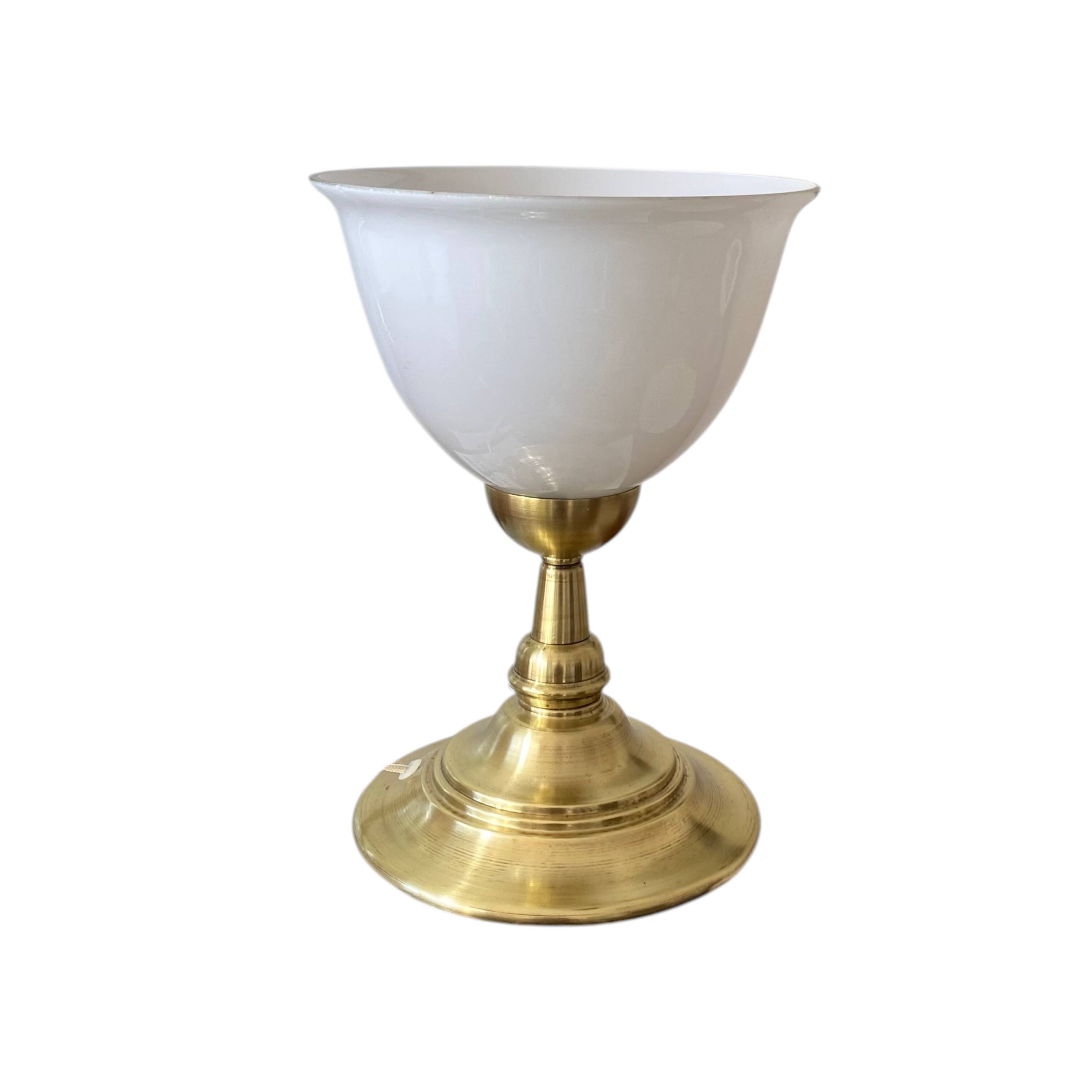 Antique white opaline glass globe table lamp with a brass base.
