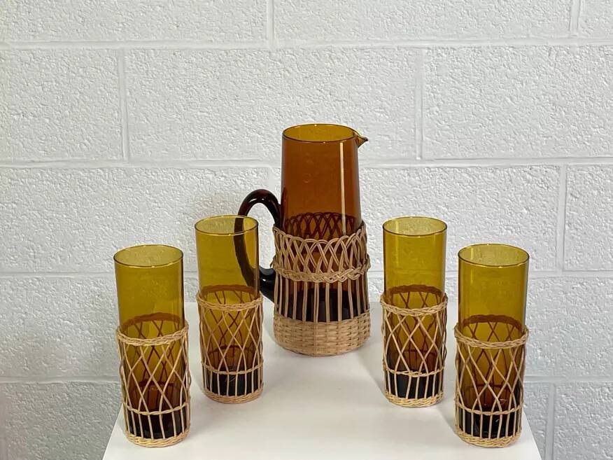 Vintage service for orangeade in amber glass and wicker.
