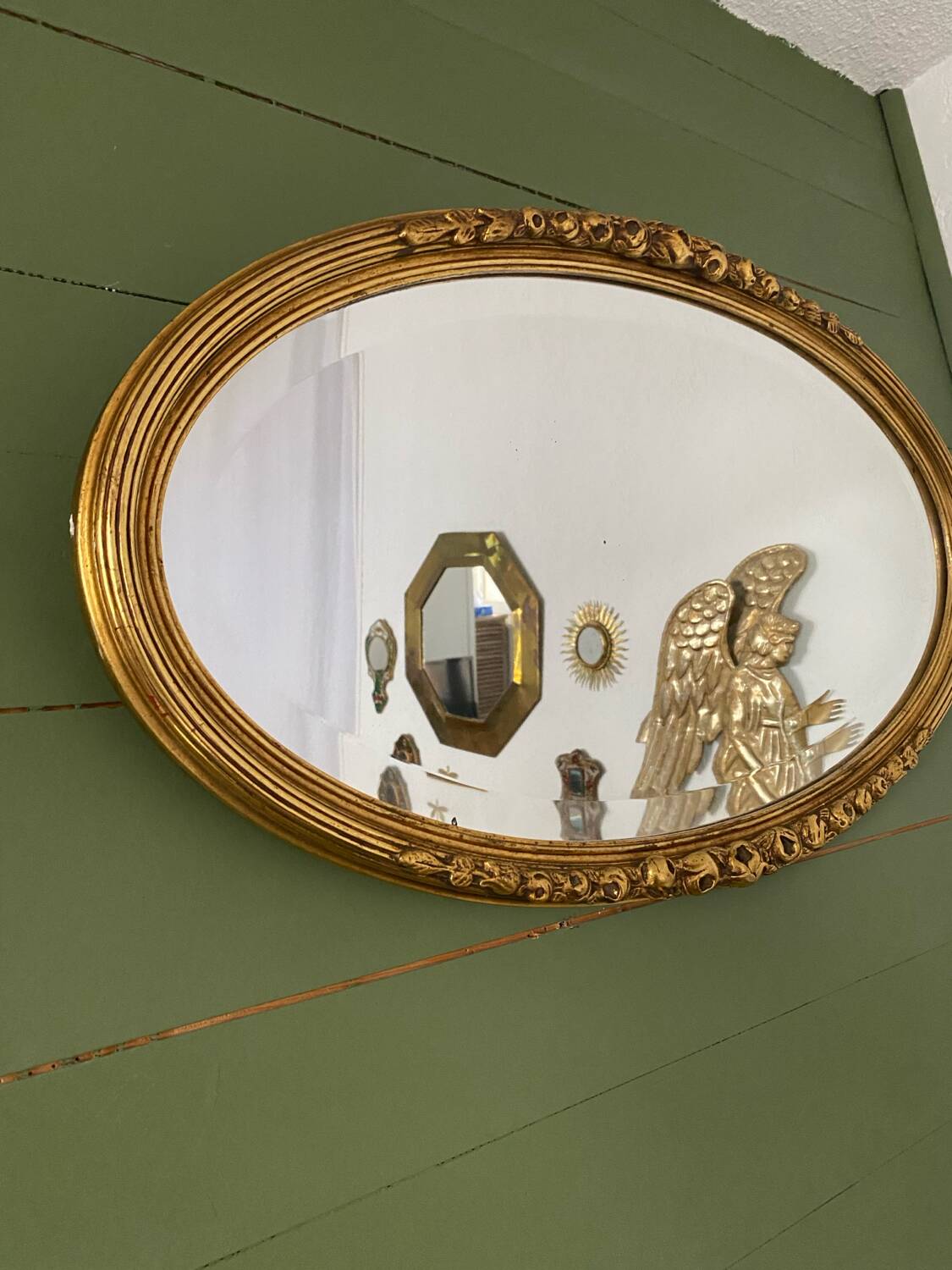 Large gold oval wall mirror
