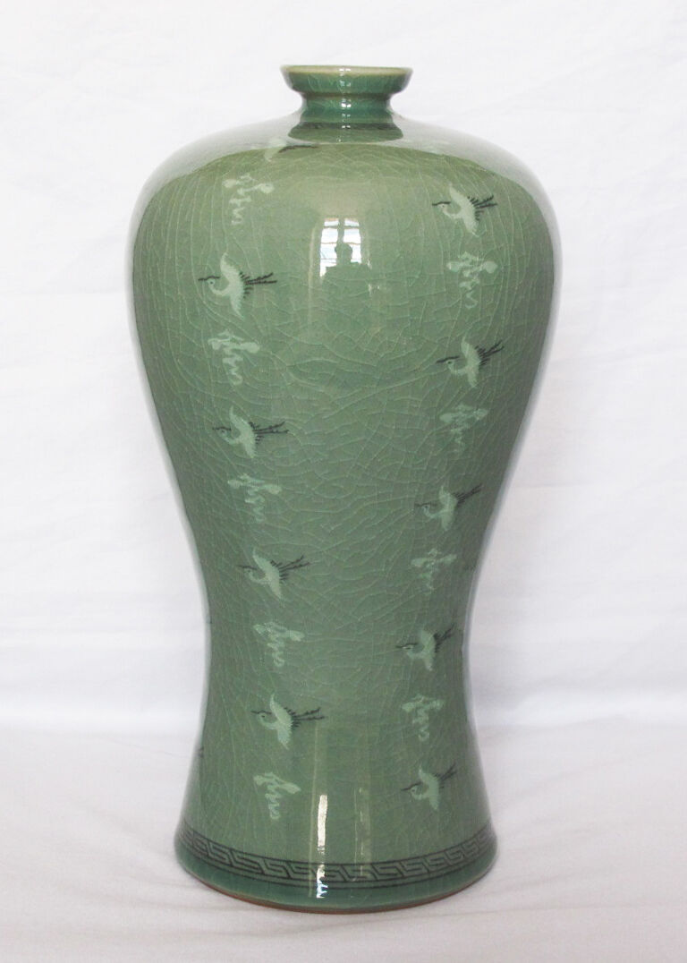 Korean vase in crackled celadon with a pattern of ducks and clouds.