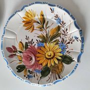 Set of three earthenware plates from Bassano, hand-painted with fruit and flower designs.