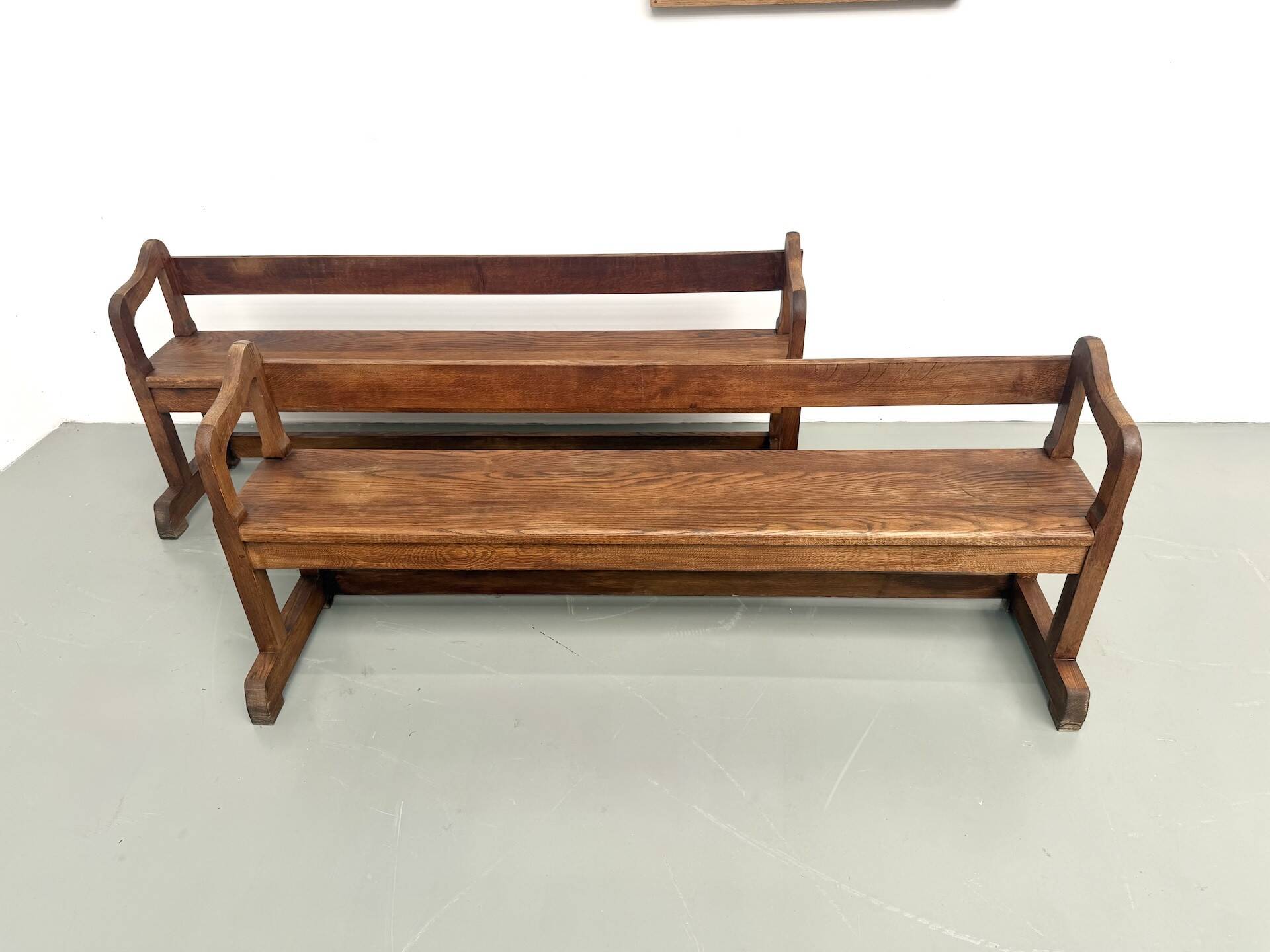 Pair of communal benches in solid oak, 1950s.