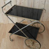 Rolling dessert in gold metal and trays in black formica