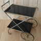 Rolling dessert in gold metal and trays in black formica