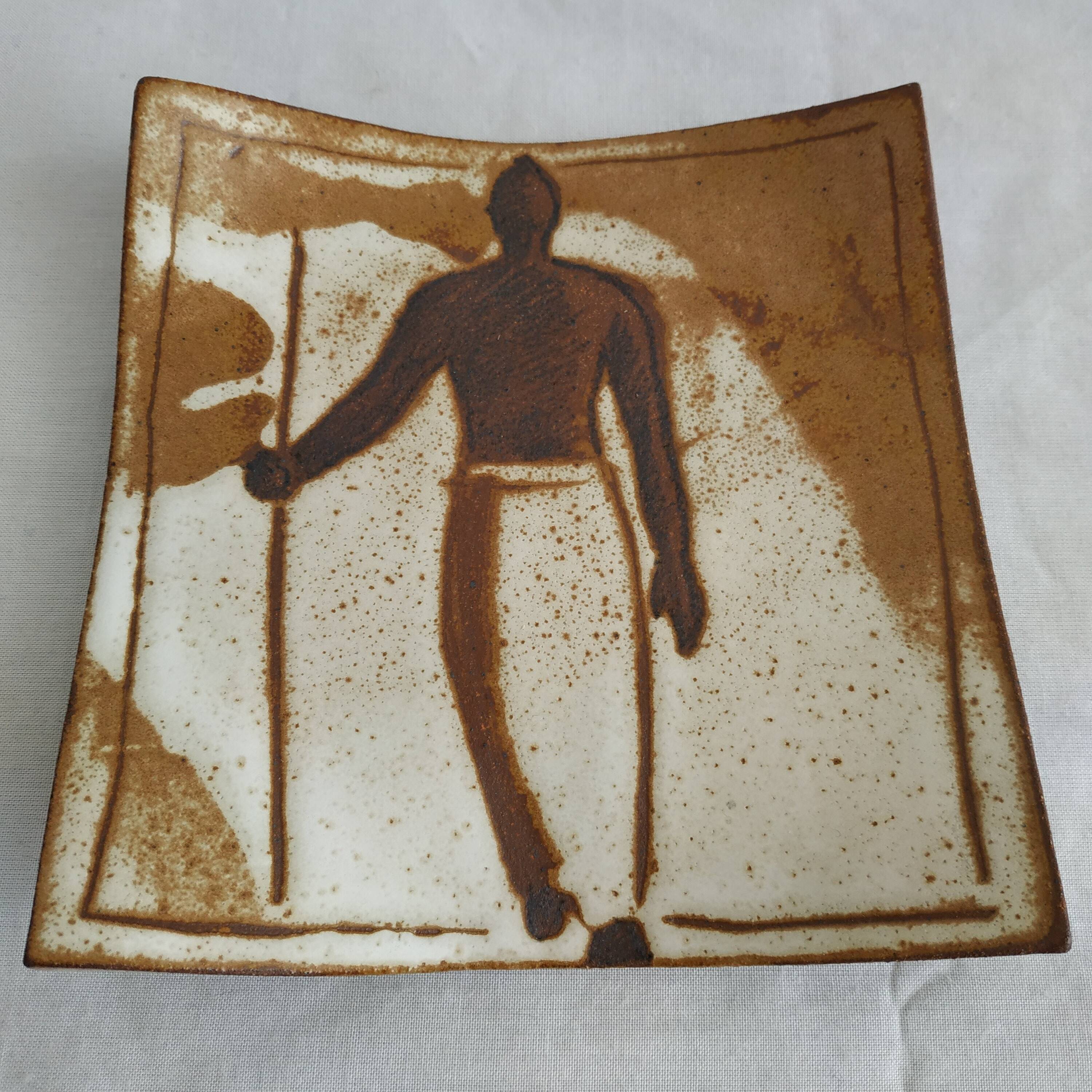 Two terracotta bowls with ethnic decoration and vintage signature.