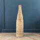 Amber glass bottle in its wicker handle basket.