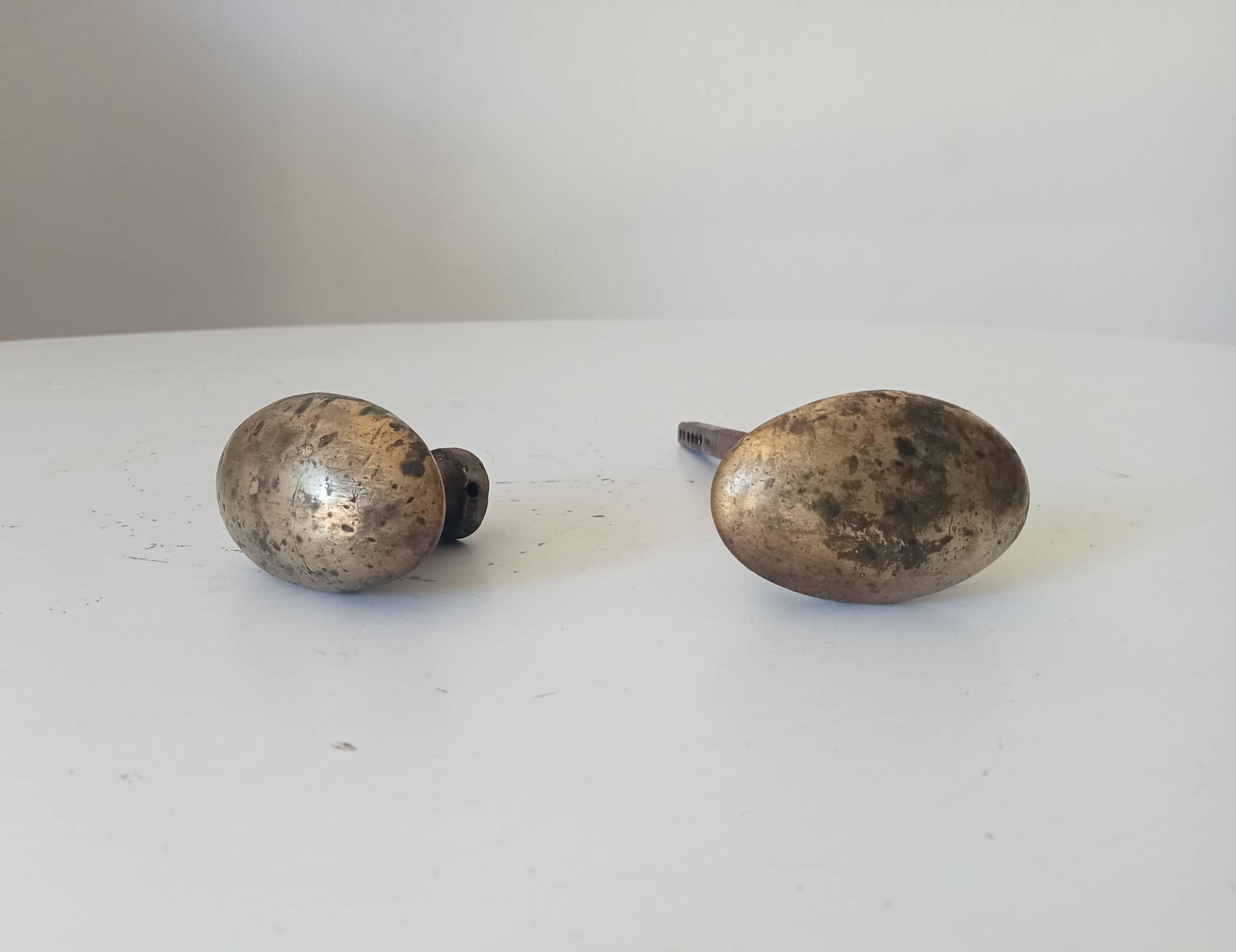 Pair of antique oval door handles in solid brass.
