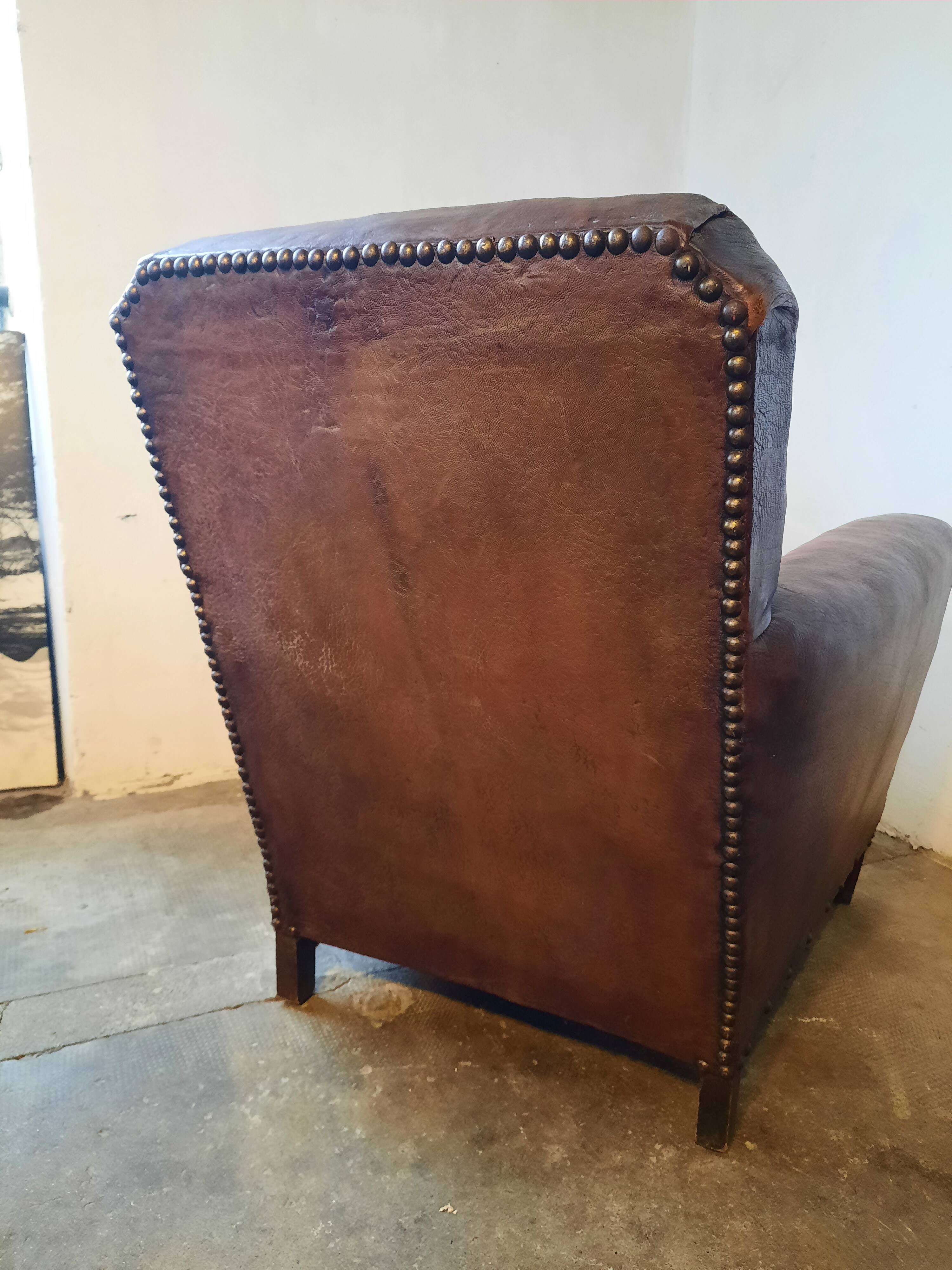 Old studded leather club chair 1930-1930