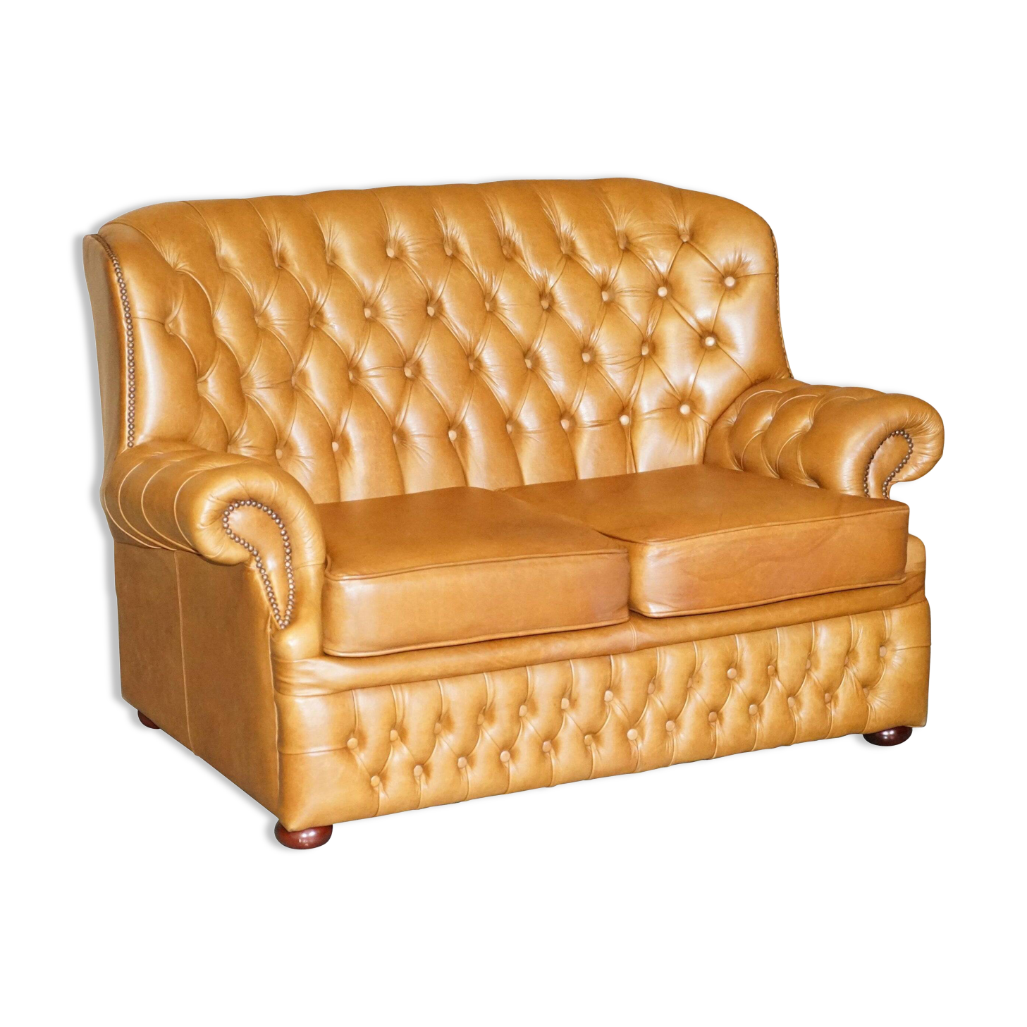 Small Chesterfield leather sofa with a high back.