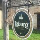 Double-sided "Loburg Beer" metal sign on wrought iron bracket